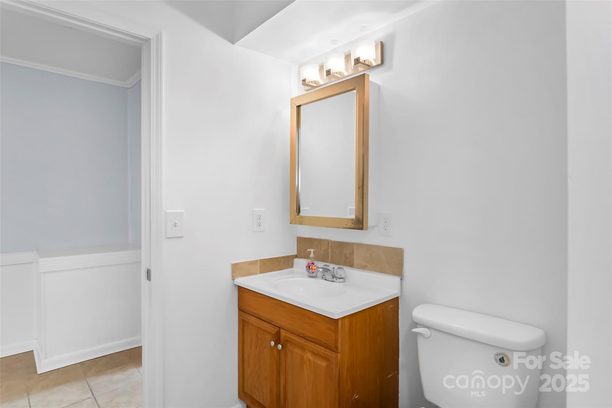 601 West 2nd Street Cherryville, NC 28021 - Photo 15 of 19 a bathroom with a sink a toilet and mirror