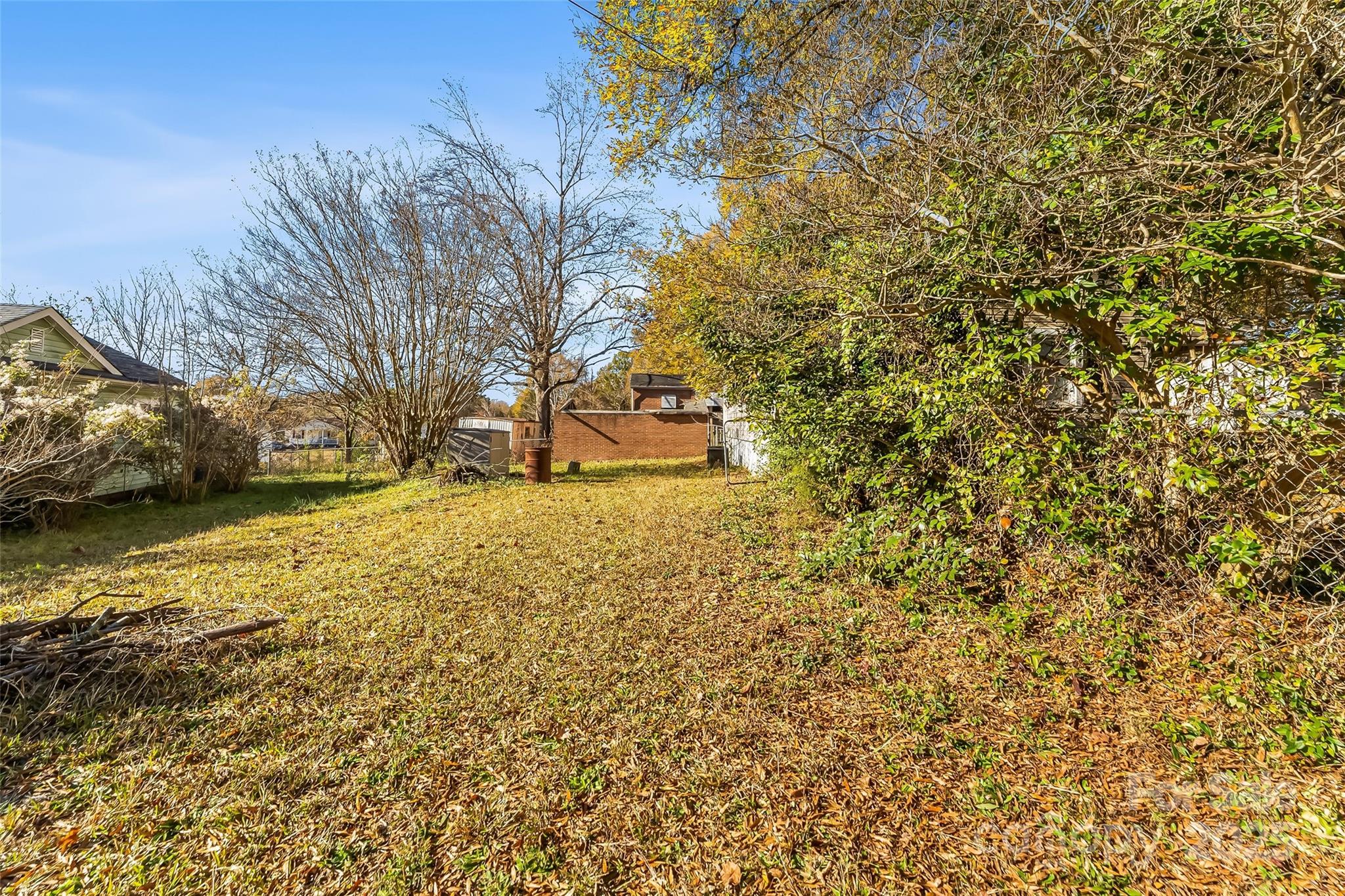 601 West 2nd Street Cherryville, NC 28021 - Photo 17 of 19 a yellow house with trees in front of it