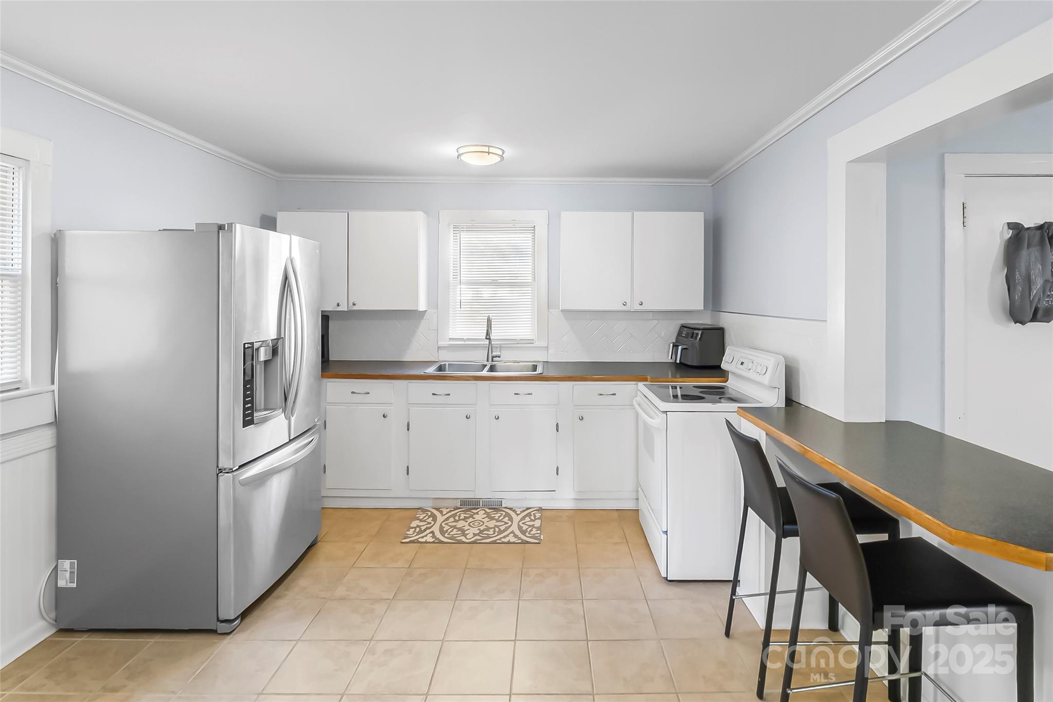 601 West 2nd Street Cherryville, NC 28021 - Photo 8 of 19 a kitchen with a stove a refrigerator and a sink