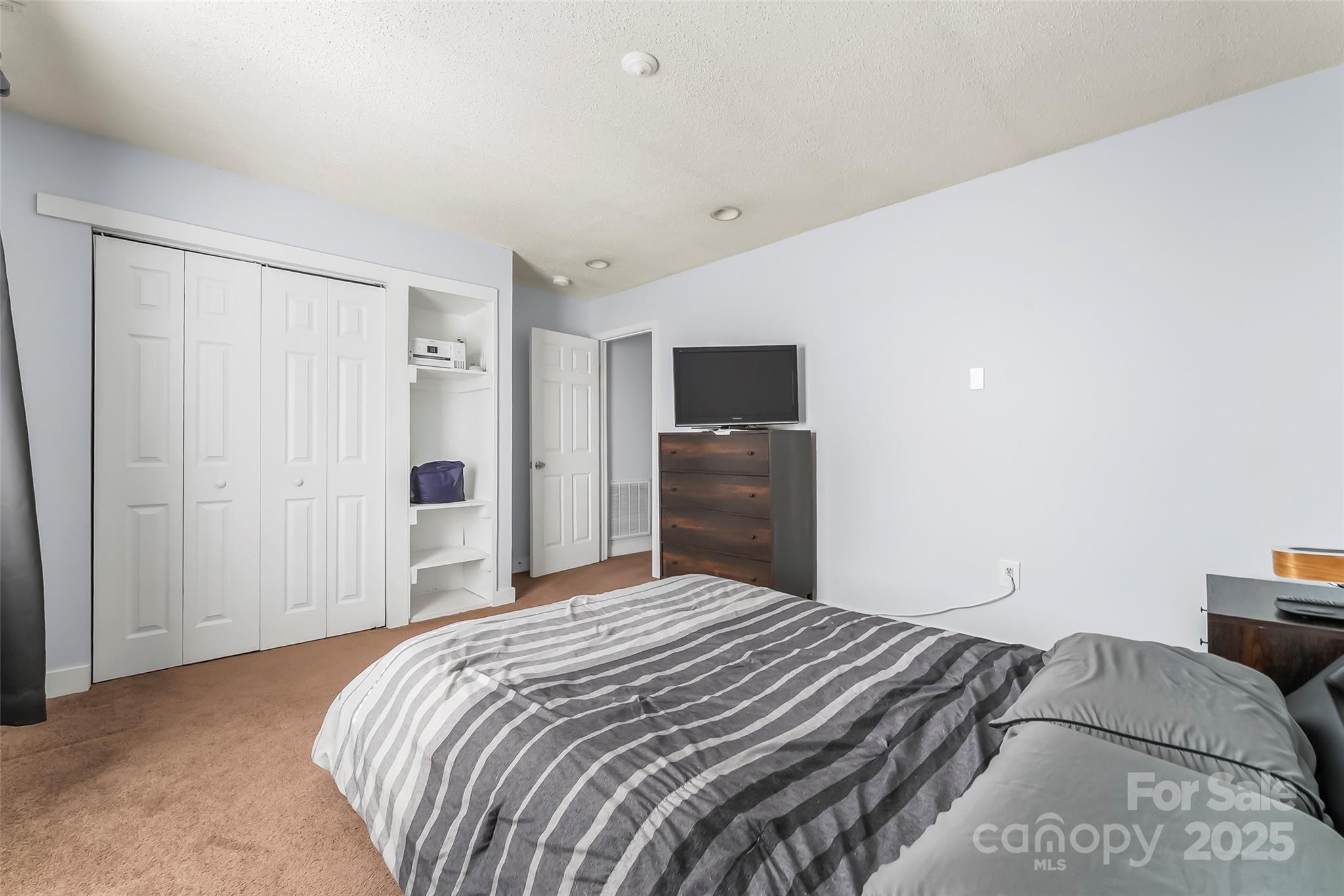 601 West 2nd Street Cherryville, NC 28021 - Photo 10 of 19 a bedroom with a bed and a television
