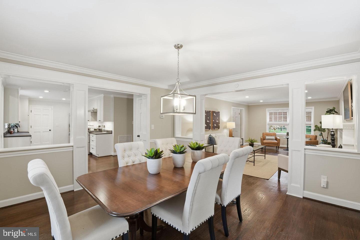 8436 Burning Tree Road Bethesda, MD 20817 - Photo 11 of 33 a view of a dining room and livingroom furniture wooden floor a rug and a chandelier