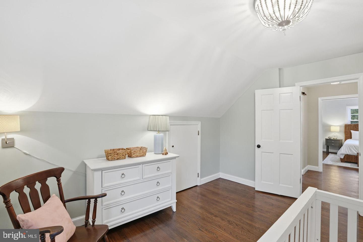 8436 Burning Tree Road Bethesda, MD 20817 - Photo 12 of 33 a bedroom with a bed and a chandelier