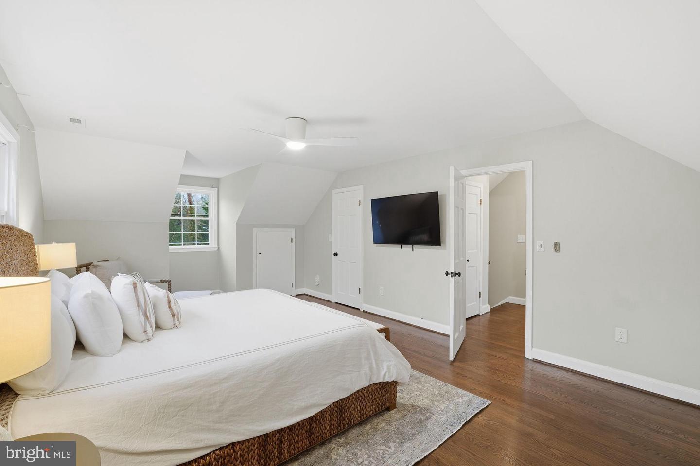 8436 Burning Tree Road Bethesda, MD 20817 - Photo 16 of 33 a bedroom with a bed and a flat screen tv