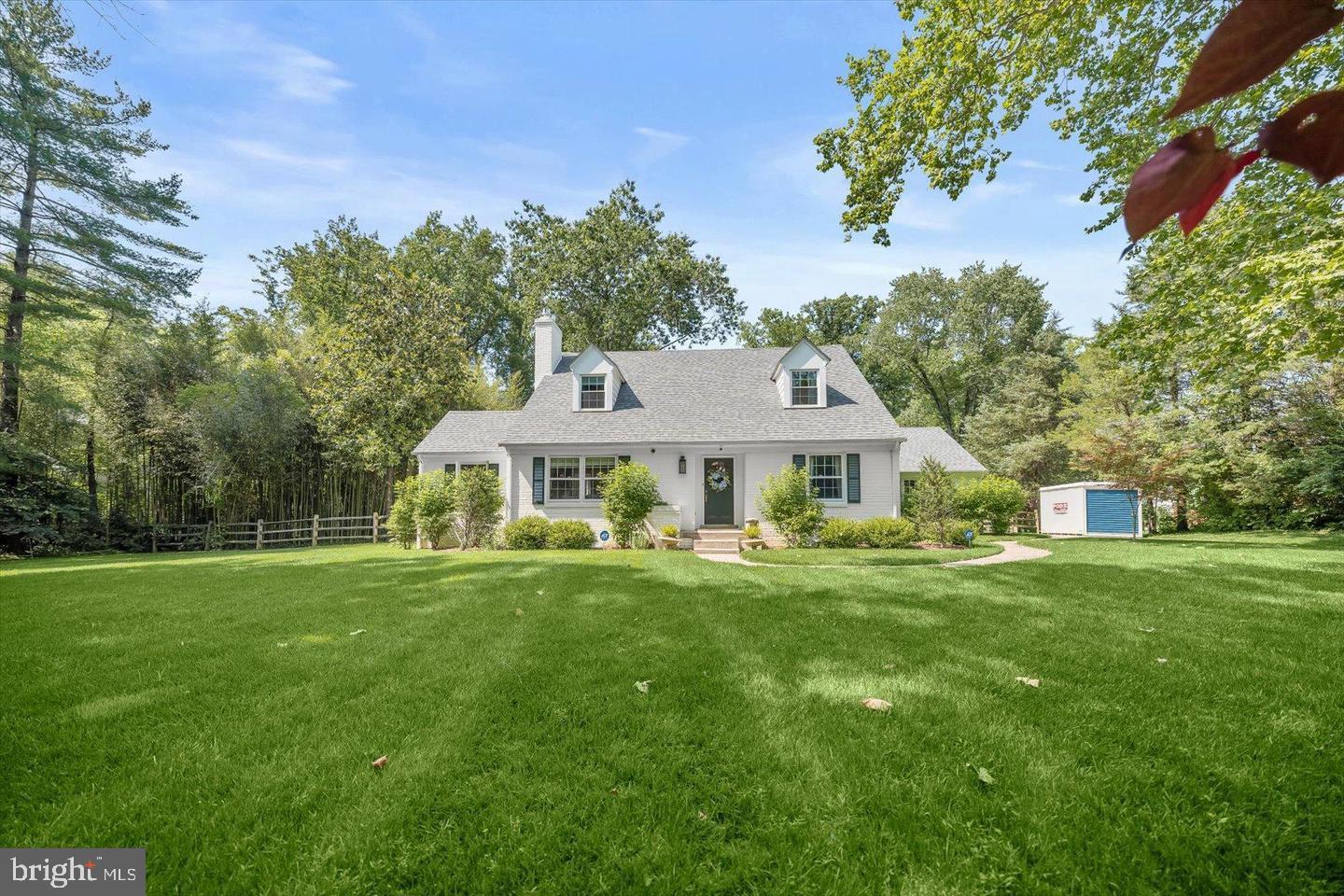 8436 Burning Tree Road Bethesda, MD 20817 - Photo 29 of 33 a front view of a house with a yard and trees
