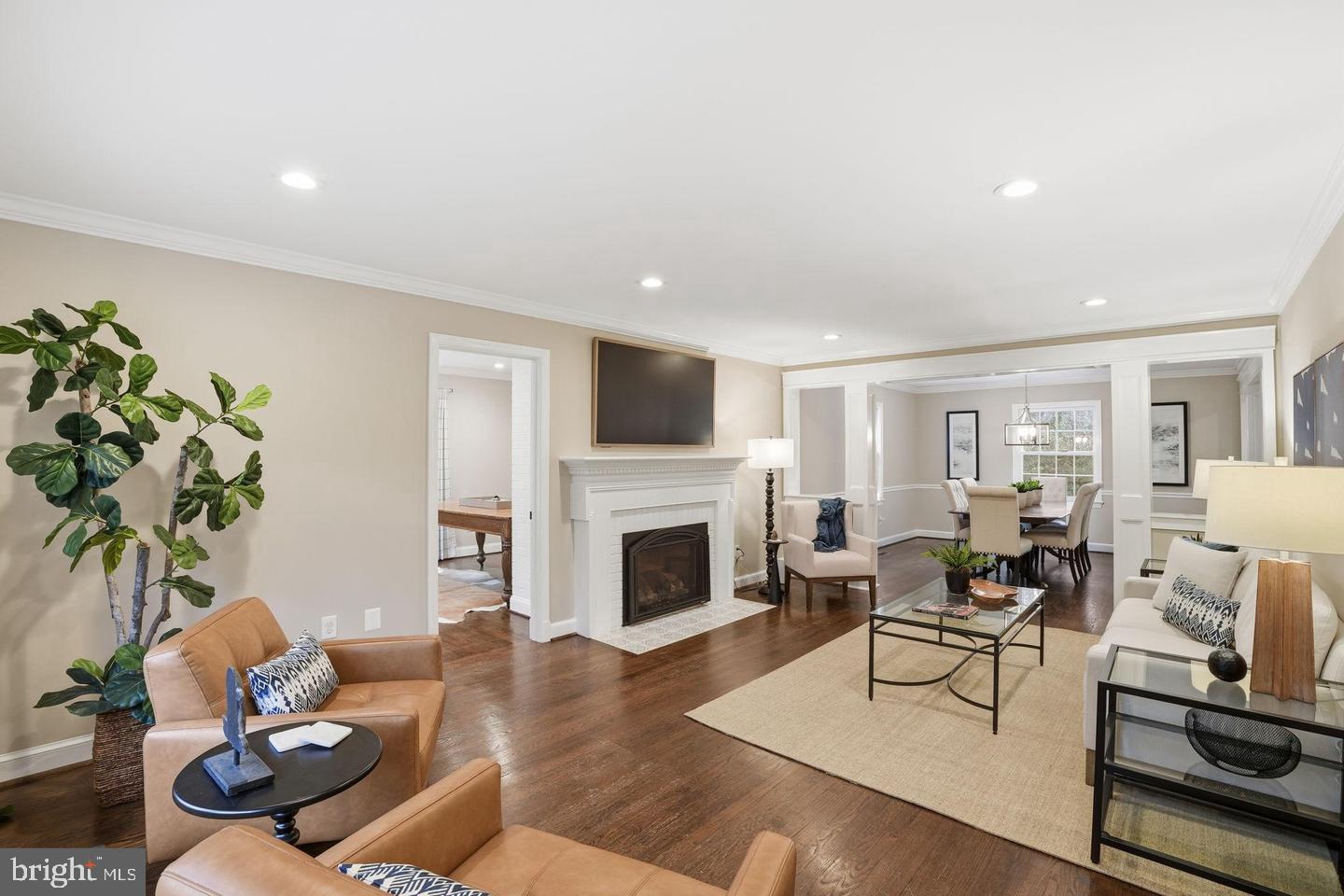 8436 Burning Tree Road Bethesda, MD 20817 - Photo 3 of 33 a living room with furniture fireplace and wooden floor
