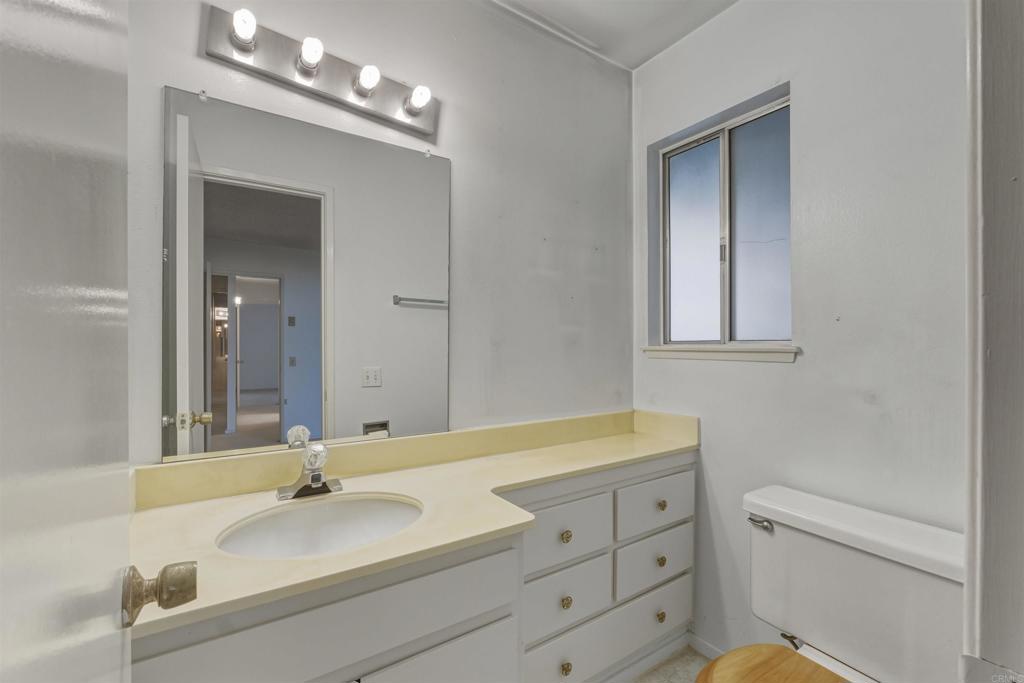 3592 Boussock Lane Oceanside, CA 92057 - Photo 13 of 24 a bathroom with a sink vanity granite toilet and a mirror