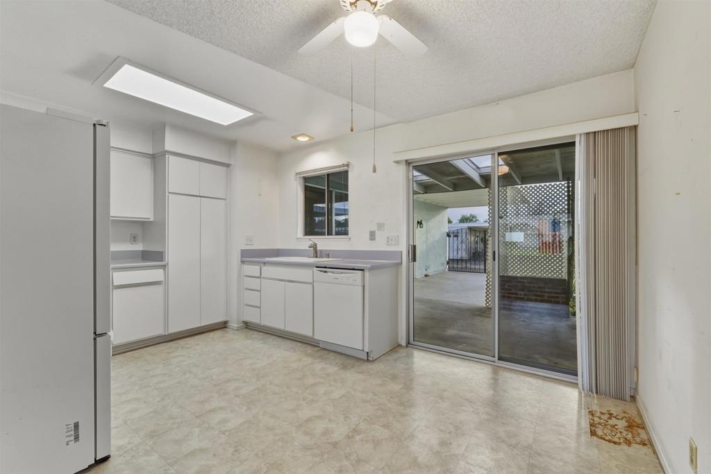 3592 Boussock Lane Oceanside, CA 92057 - Photo 6 of 24 a room with a chandelier fan and kitchen view