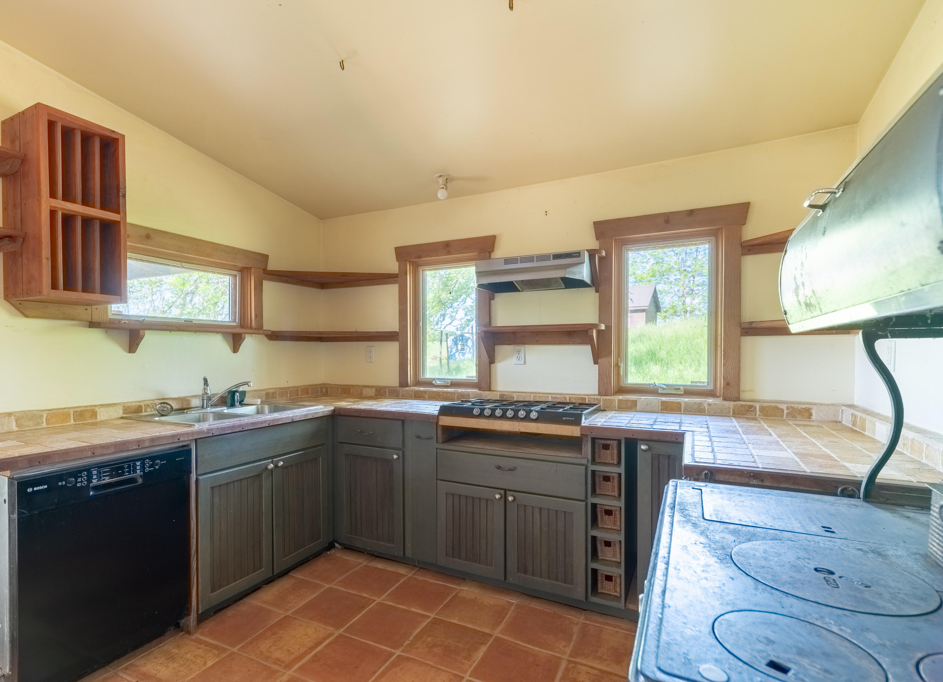 483 Eanes Road Northeast Check, VA 24072 - Photo 5 of 31 a kitchen with a sink stove and cabinets