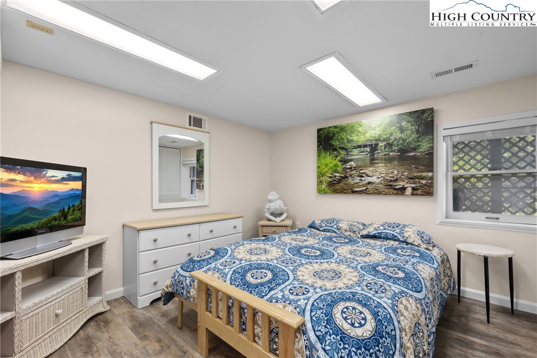 17 Elderberry Loop Newland, NC 28657 - Photo 27 of 47 a bedroom with a bed and a flat screen tv