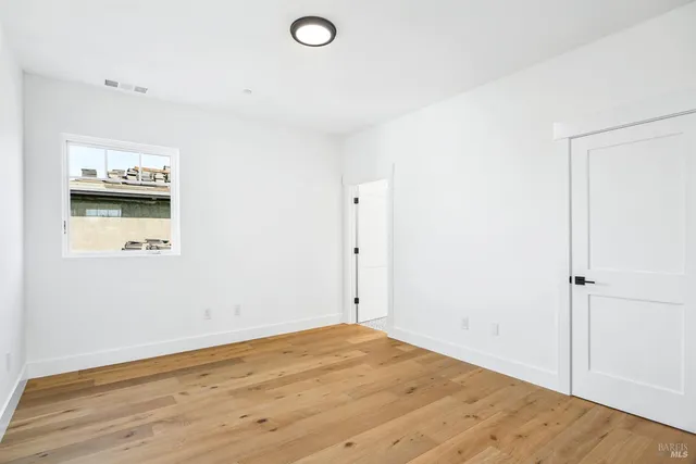 a view of a room with wooden floor