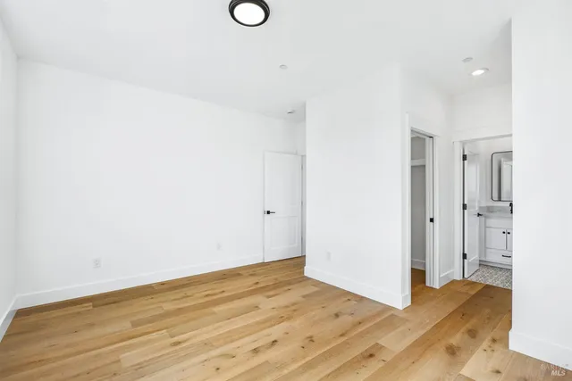 a view of a room with wooden floor