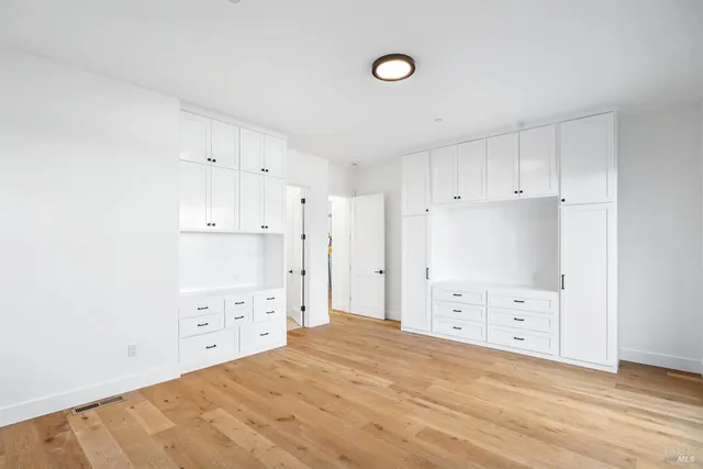 a view of empty room with cabinet