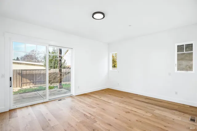 a kitchen with stainless steel appliances a sink a window and a refrigerator
