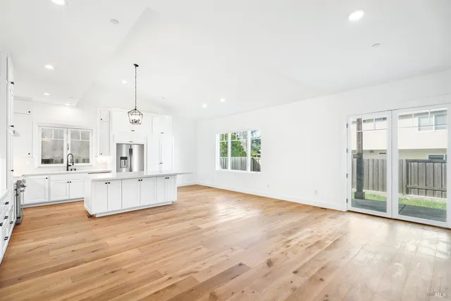a large white kitchen with a large window
