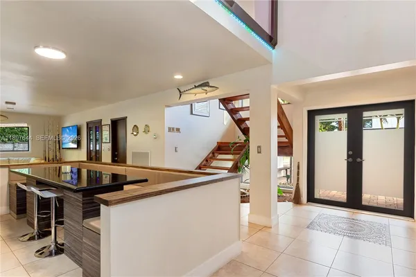 a bathroom with a granite countertop sink a toilet a mirror and shower
