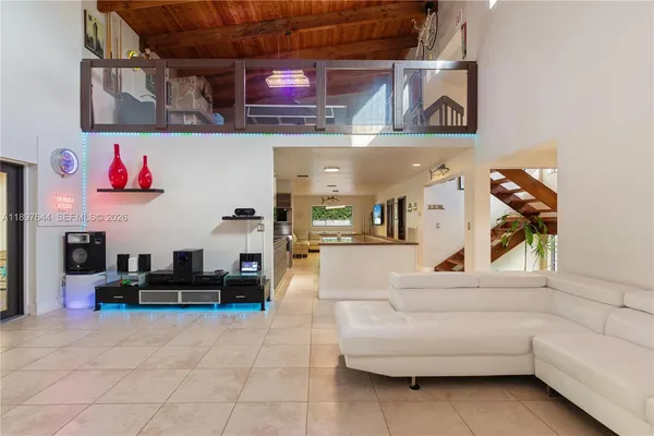 a view of a patio with table and chairs potted plants with wooden floor