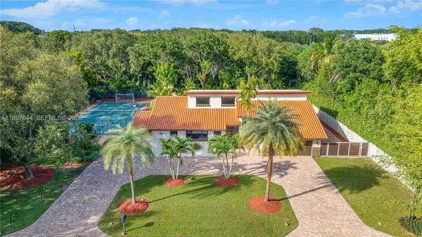 a kitchen that has a sink and a stove with granite countertops