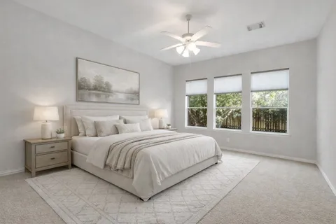 a bedroom with a large bed and a window