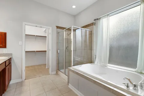 a bathroom with a bathtub and a shower