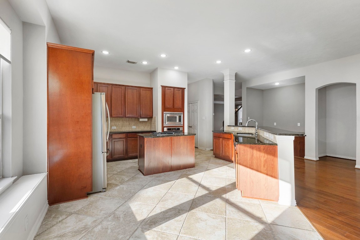 80 North Frontera Circle Spring, TX 77382 - Photo 6 of 28 a large kitchen with stainless steel appliances kitchen island granite countertop a refrigerator and a sink