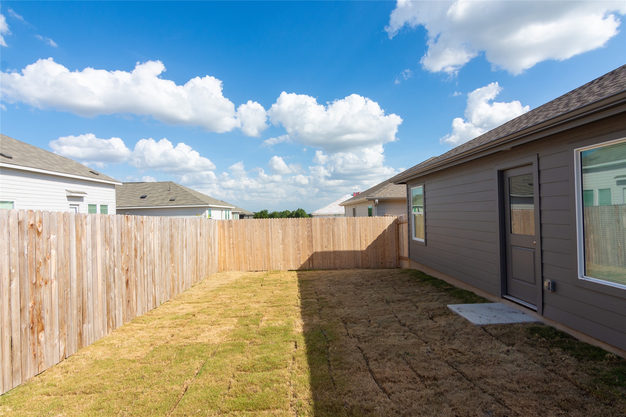 149 Star Packer Lane Jarrell, TX 76537 - Photo 29 of 30 A newly installed wooden fence creates a private outdoor sanctuary, perfect for relaxation and recreation.