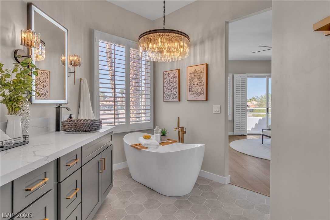8848 Rainbow Ridge Drive Las Vegas, NV 89117 - Photo 34 of 43 Indulge in a luxurious freestanding tub, poised for relaxation in this tranquil bathroom.