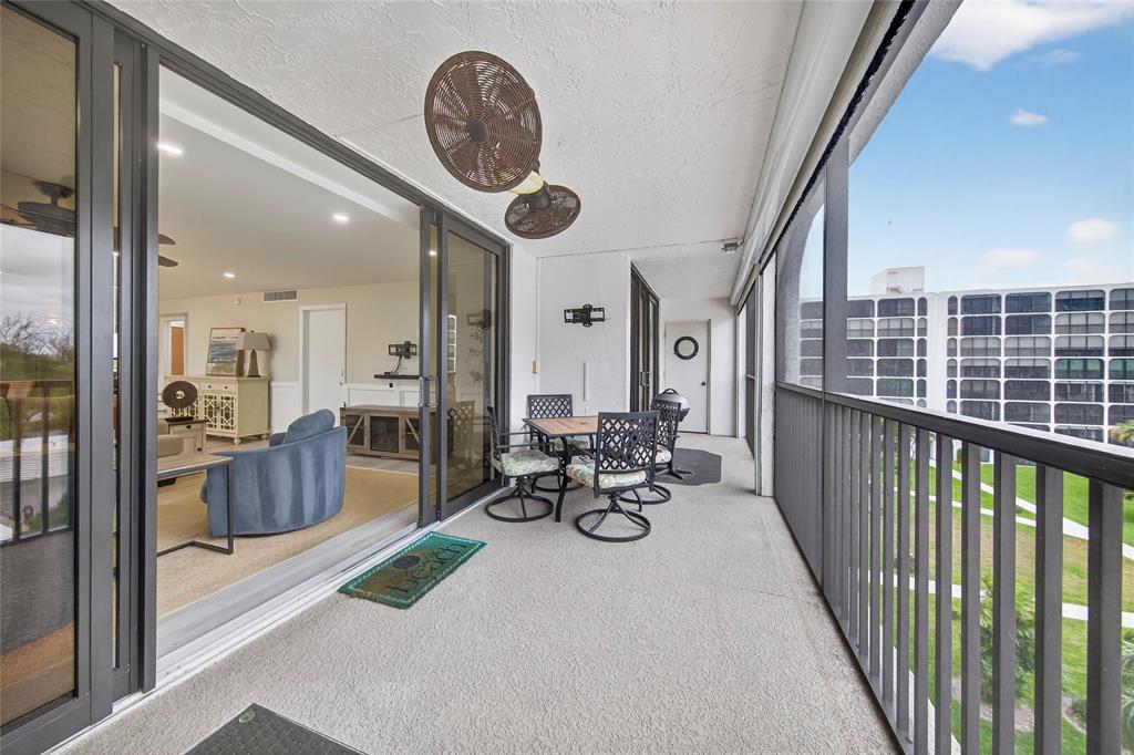 1629 Riverview Road, Unit 521 Deerfield Beach, FL 33441 - Photo 24 of 54 a view of a chairs and tables in the balcony