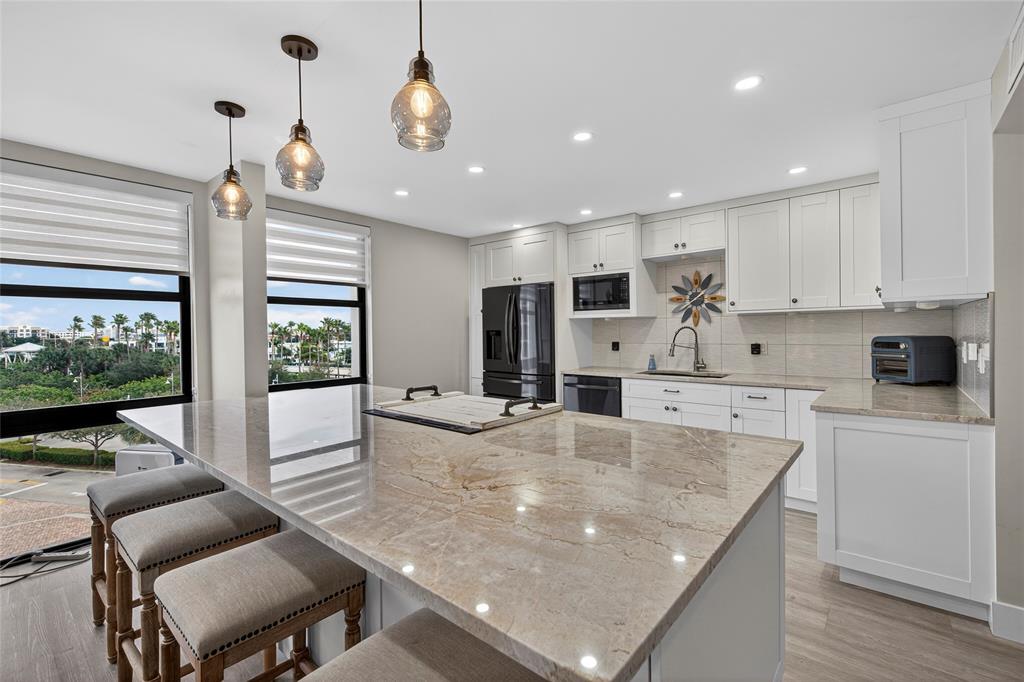 1629 Riverview Road, Unit 521 Deerfield Beach, FL 33441 - Photo 27 of 54 a large kitchen with kitchen island a large island in it
