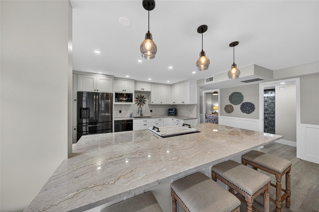 1629 Riverview Road, Unit 521 Deerfield Beach, FL 33441 - Photo 28 of 54 a large kitchen with a table and chairs