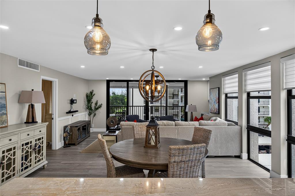 1629 Riverview Road, Unit 521 Deerfield Beach, FL 33441 - Photo 33 of 54 a view of a dining room with furniture large windows and wooden floor