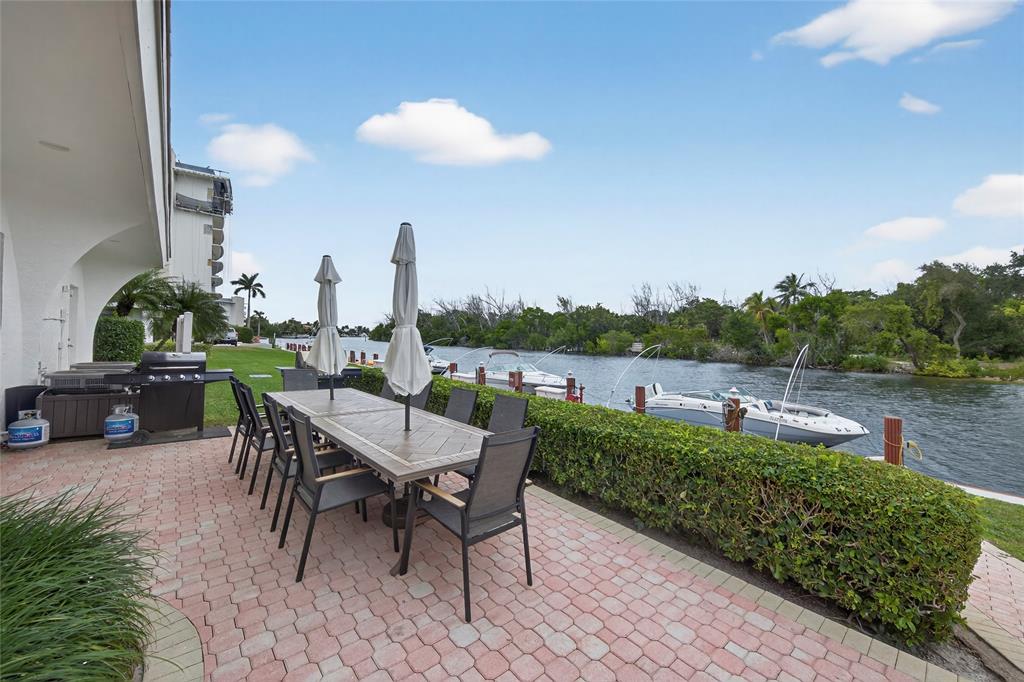 1629 Riverview Road, Unit 521 Deerfield Beach, FL 33441 - Photo 49 of 54 a view of a patio with a table and chairs