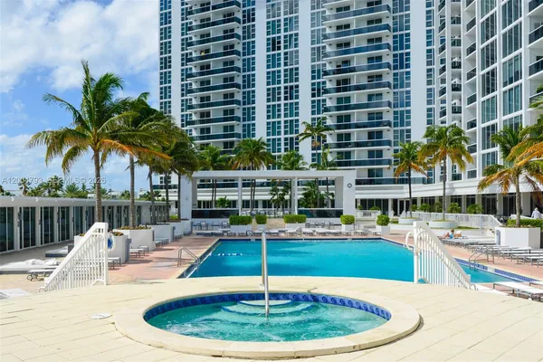 a swimming pool with outdoor seating