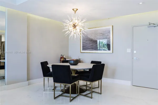a dining room with furniture and chandelier