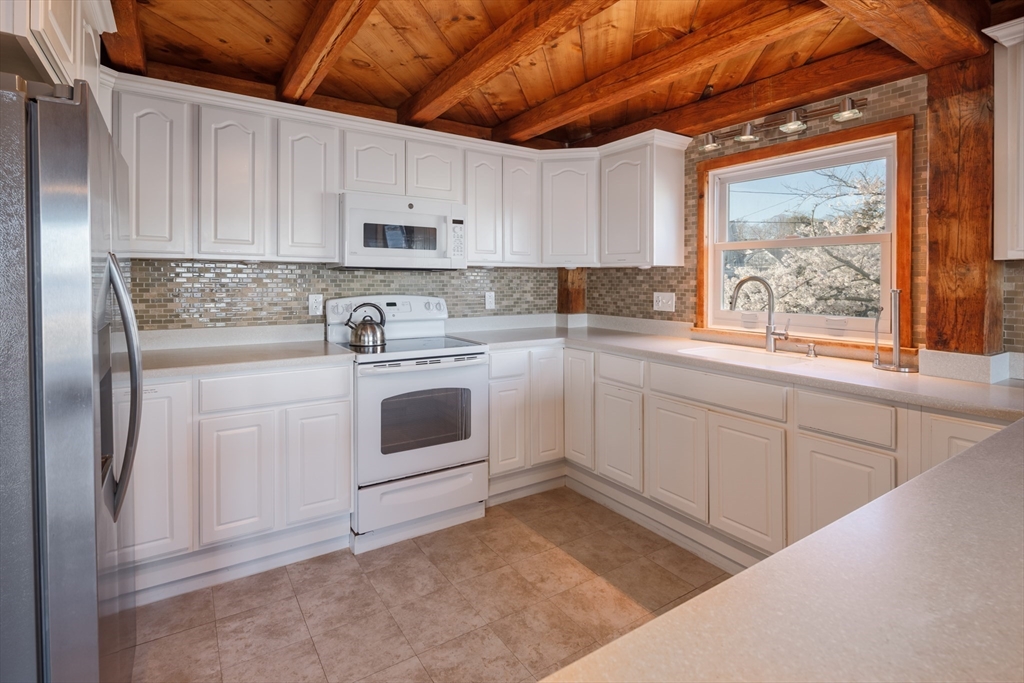 71 Willow Road Nahant, MA 01908 - Photo 15 of 30 a kitchen with white cabinets stainless steel appliances and sink