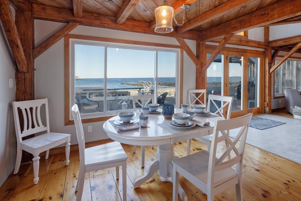 71 Willow Road Nahant, MA 01908 - Photo 18 of 30 a view of a dining room with furniture large windows and wooden floor