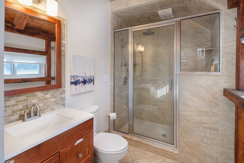 71 Willow Road Nahant, MA 01908 - Photo 21 of 30 a bathroom with a sink vanity granite toilet and shower