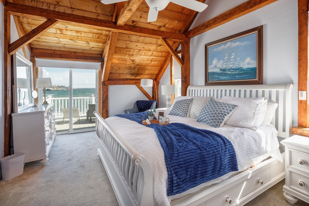 71 Willow Road Nahant, MA 01908 - Photo 22 of 30 a bedroom with a balcony a bed and a painting on the wall