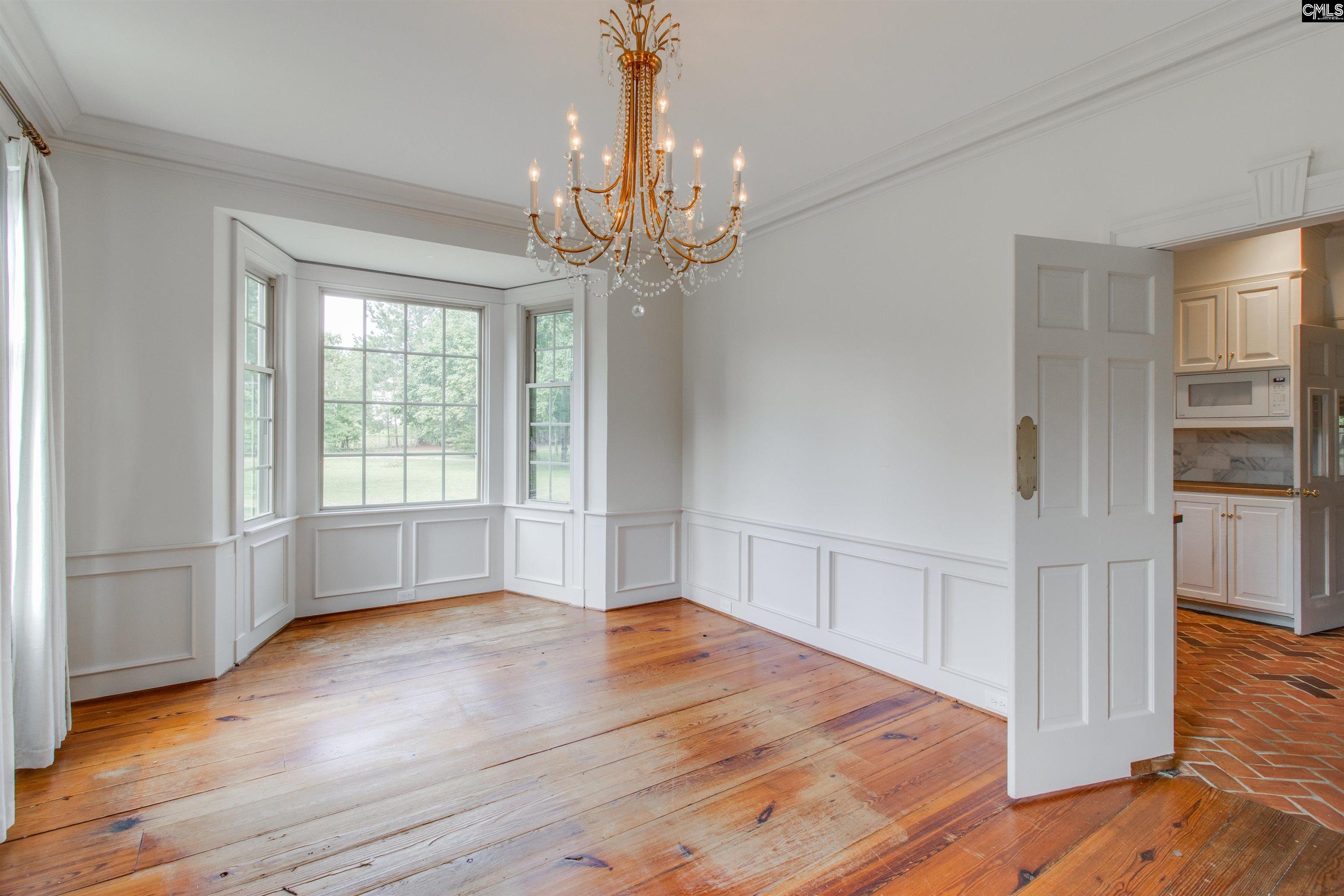 701 Longtown Road Columbia, SC 29229 - Photo 10 of 26 a view of an empty room with wooden floor and a window