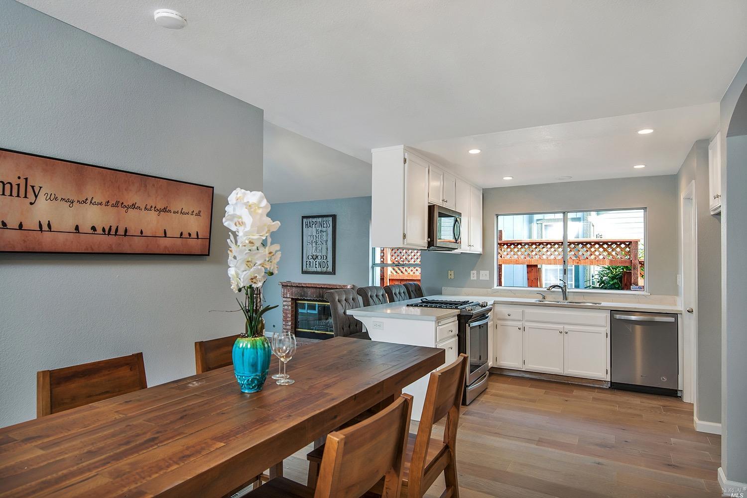 2150 Bock Street Santa Rosa, CA 95403 - Photo 1 of 1 a kitchen with stainless steel appliances a table and chairs in it