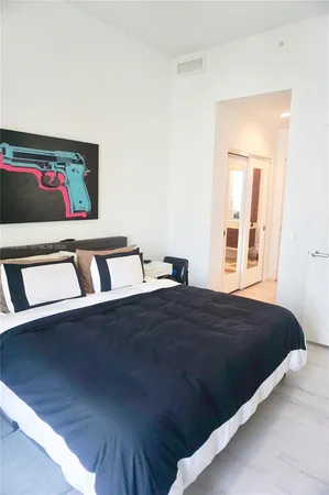 a bedroom with a bed and window