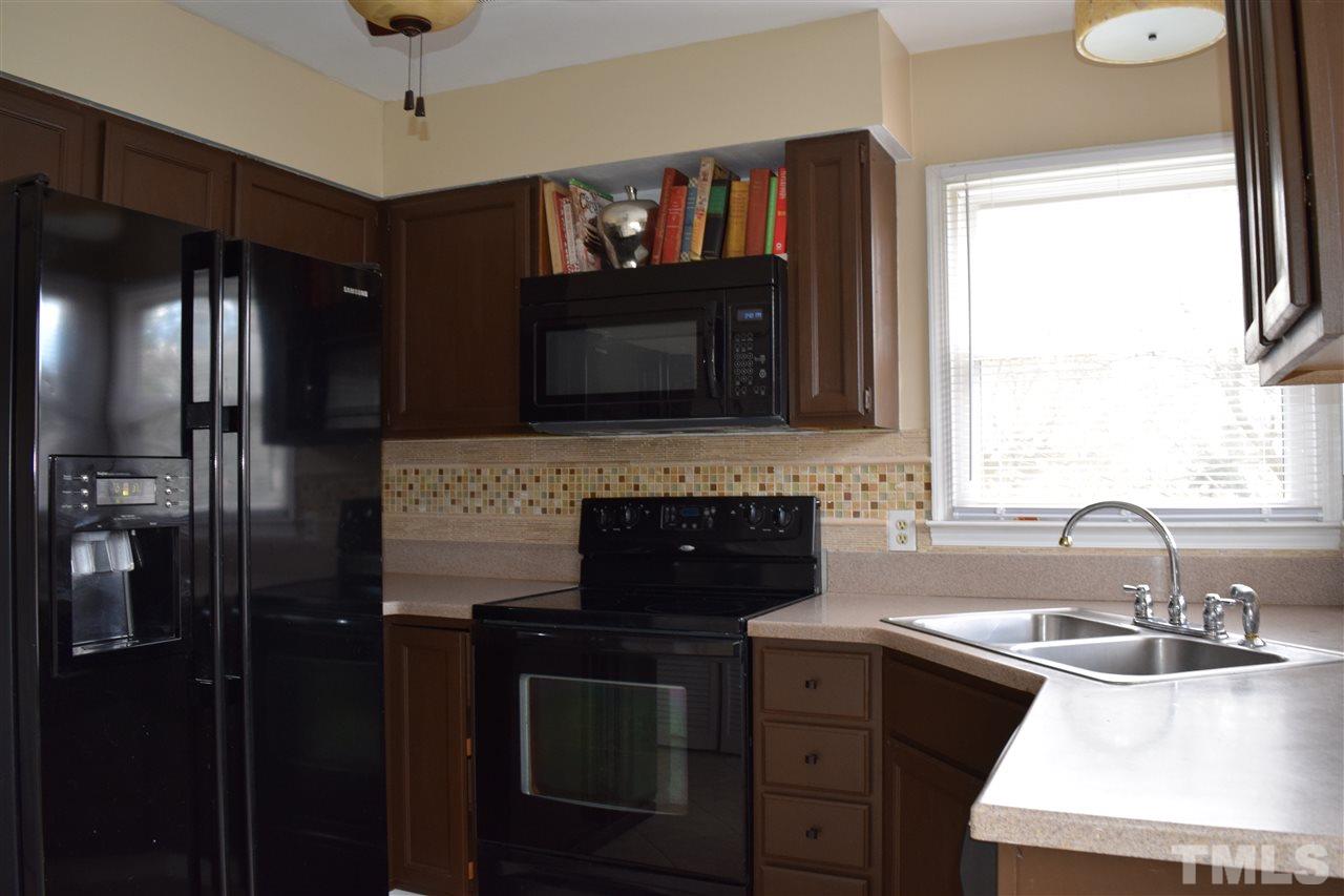 4404 Lake Ridge Drive Raleigh, NC 27604 - Photo 4 of 24 a kitchen with a sink appliances and cabinets
