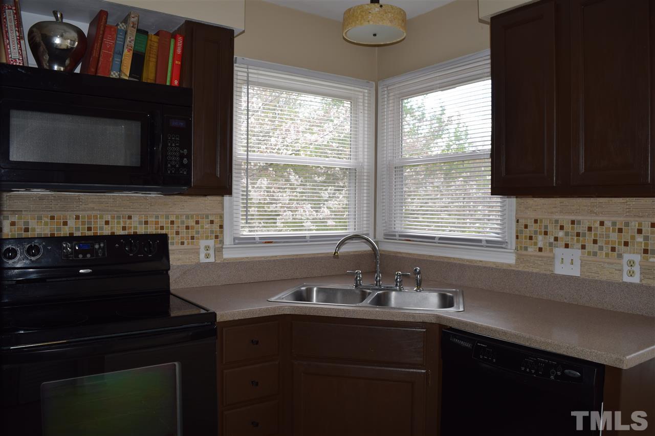 4404 Lake Ridge Drive Raleigh, NC 27604 - Photo 5 of 24 a kitchen with a sink cabinets and a window