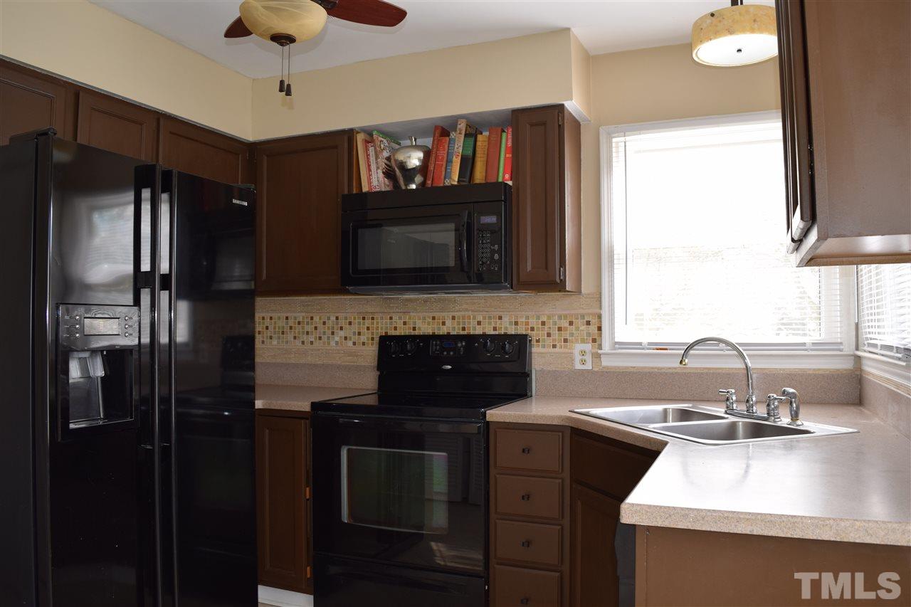 4404 Lake Ridge Drive Raleigh, NC 27604 - Photo 7 of 24 a kitchen with a sink stove and refrigerator