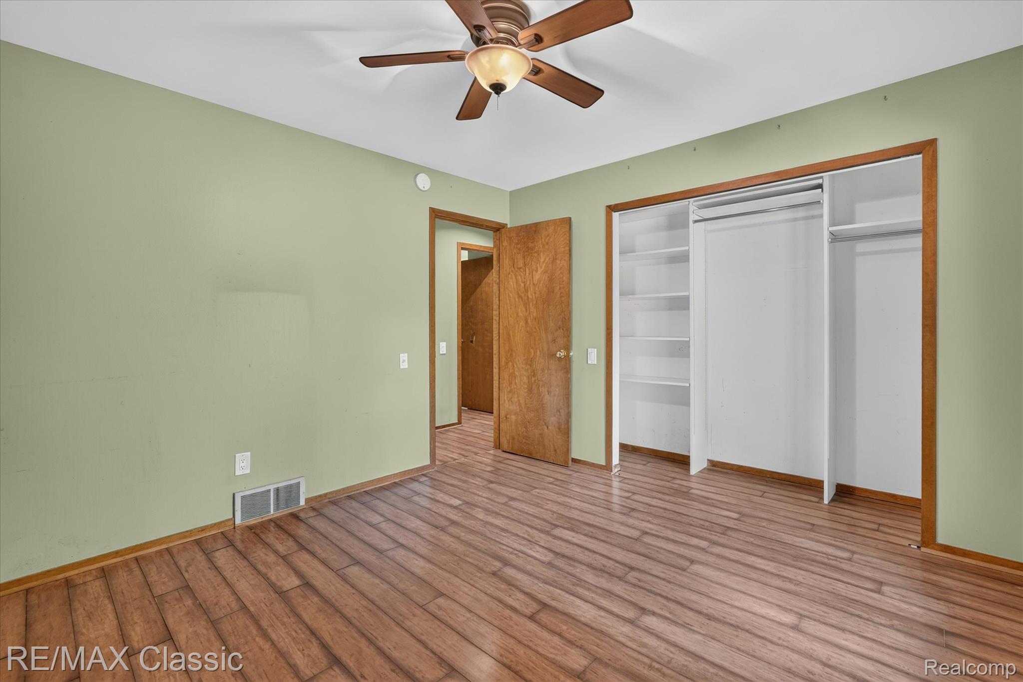 12189 Gage Road Holly, MI 48442 - Photo 24 of 69 Interior room featuring wood-finish flooring and light green walls