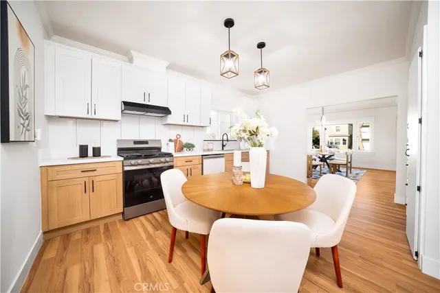 a large kitchen with a table and chairs