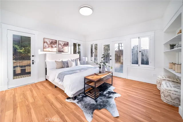 a bedroom with a bed and wooden floor