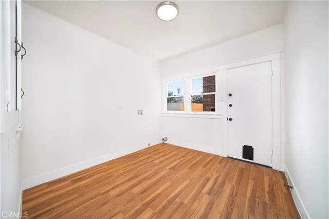 a view of empty room with wooden floor