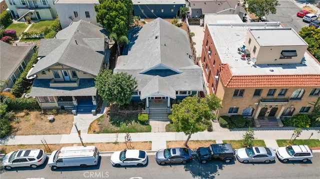 an aerial view of a house with car parked