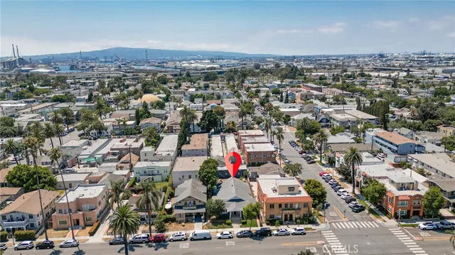 an aerial view of residential houses with city view