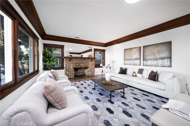 a living room with furniture a large window and a fireplace